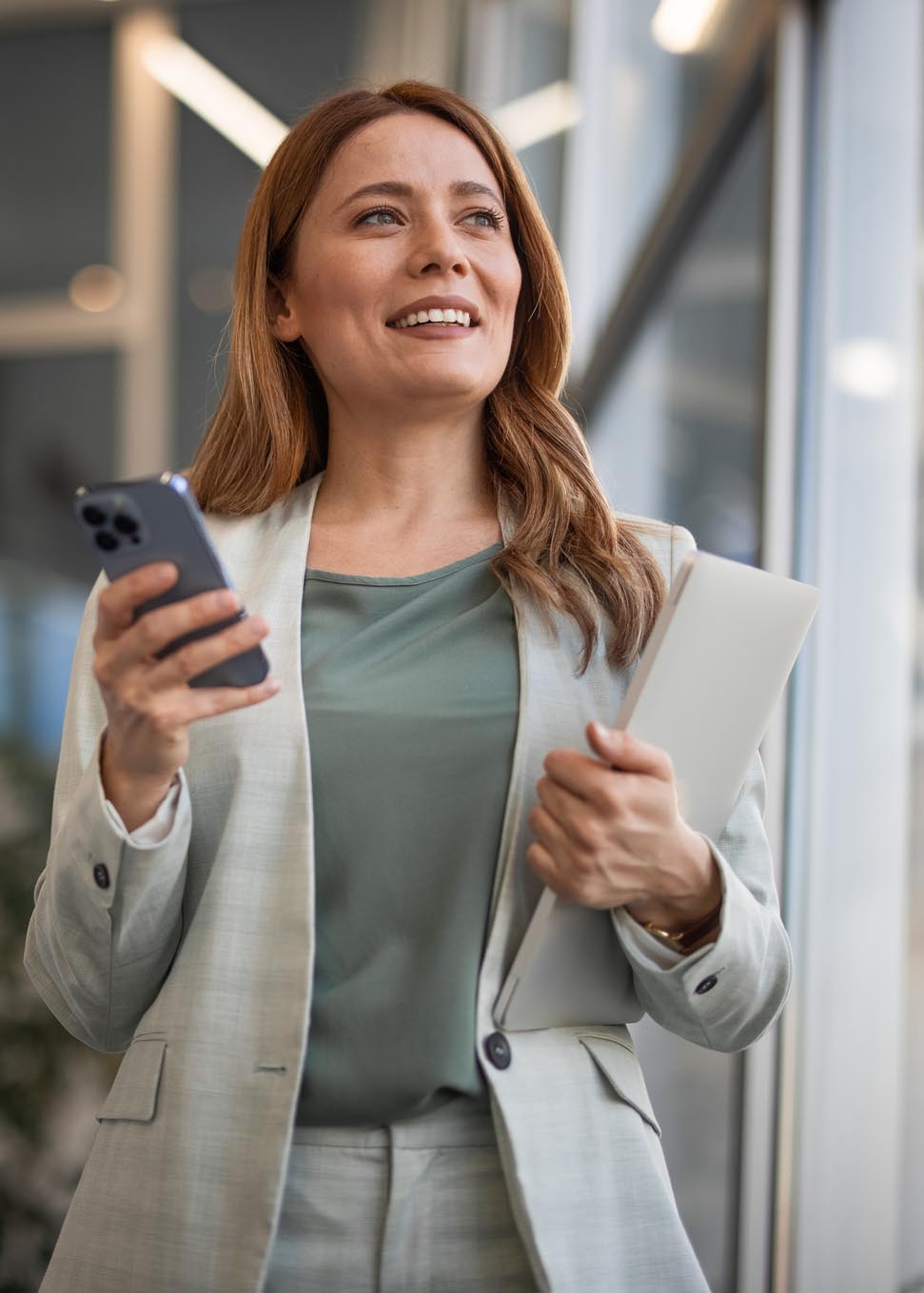 woman looking up vert crop GettyImages-2042565503 businesswoman looking up and smiling